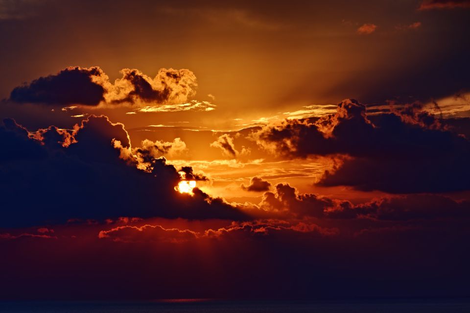 The Sun Slipping Through a Sea of Clouds